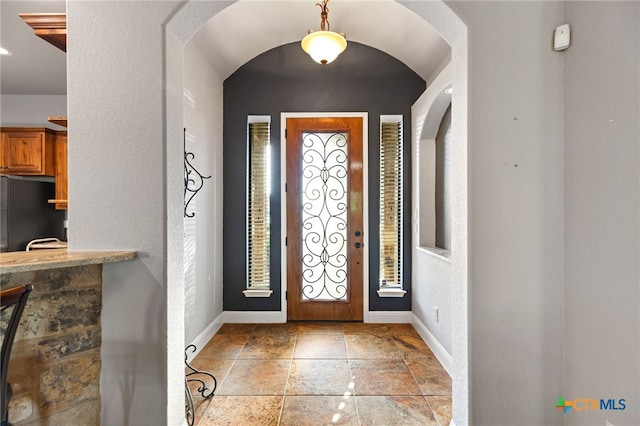 2299 Sun Chase Blvd, New Braunfels, TX 78130 - foyer with stone tile flooring and arched walkways