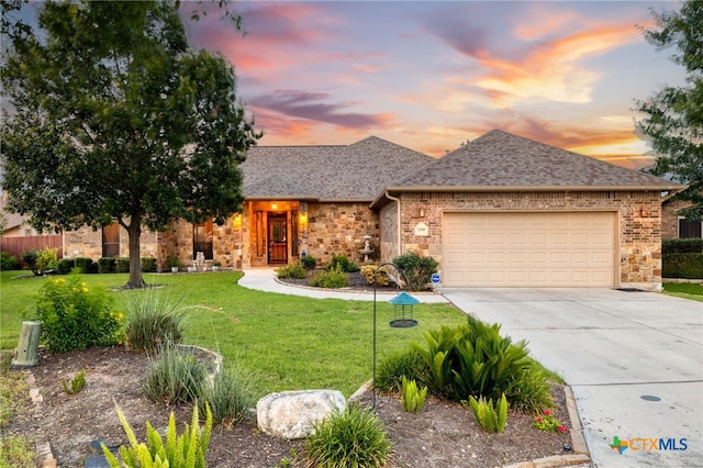 2299 Sun Chase Blvd, New Braunfels, TX 78130 - view of front of home featuring concrete driveway, an attached garage, a yard, a shingled roof, and brick siding