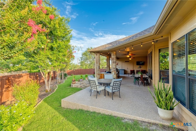 2299 Sun Chase Blvd, New Braunfels, TX 78130 - fenced backyard featuring a patio area, outdoor dining area, and ceiling fan