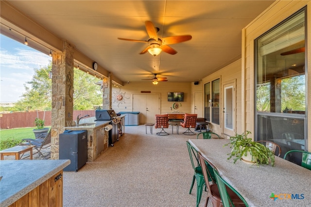 2299 Sun Chase Blvd, New Braunfels, TX 78130 - view of patio / terrace featuring outdoor dining area, an outdoor kitchen, and ceiling fan