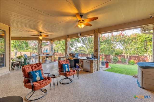 2299 Sun Chase Blvd, New Braunfels, TX 78130 - fenced backyard featuring outdoor dining area, ceiling fan, a patio, and exterior kitchen