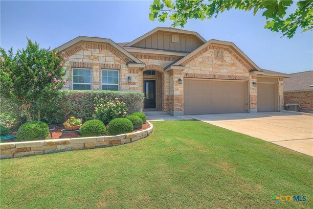 6010 Ballast Trl, New Braunfels, TX 78132 - view of front of house featuring an attached garage, a front lawn, driveway, board and batten siding, and central AC