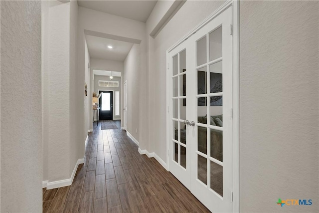 6010 Ballast Trl, New Braunfels, TX 78132 - hall with french doors, a textured wall, dark wood-style flooring, and baseboards