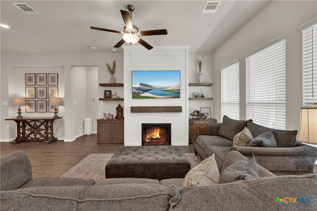 6010 Ballast Trl, New Braunfels, TX 78132 - living room with dark wood finished floors, ceiling fan, a fireplace, and baseboards