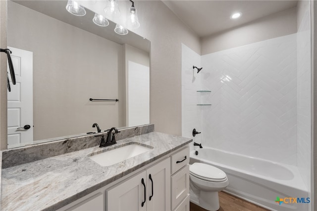 full bathroom featuring hardwood / wood-style floors, shower / washtub combination, toilet, and vanity