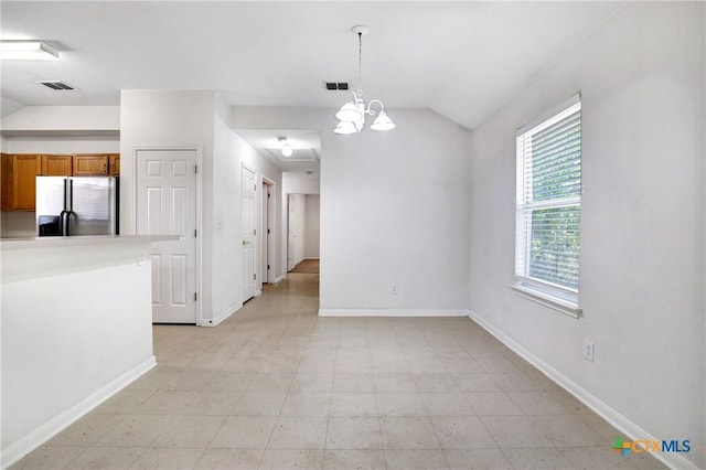 unfurnished dining area with vaulted ceiling and a notable chandelier