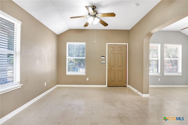 foyer with ceiling fan and lofted ceiling