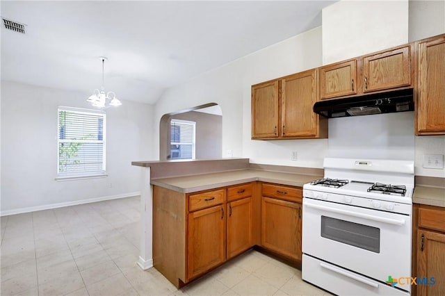 kitchen featuring pendant lighting, white gas range, lofted ceiling, kitchen peninsula, and an inviting chandelier