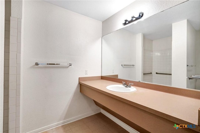 bathroom featuring walk in shower and sink