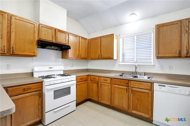 kitchen with lofted ceiling, sink, and white appliances