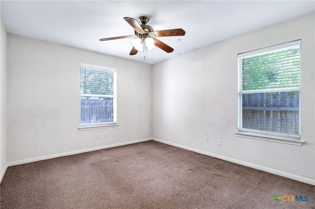 empty room with ceiling fan and carpet