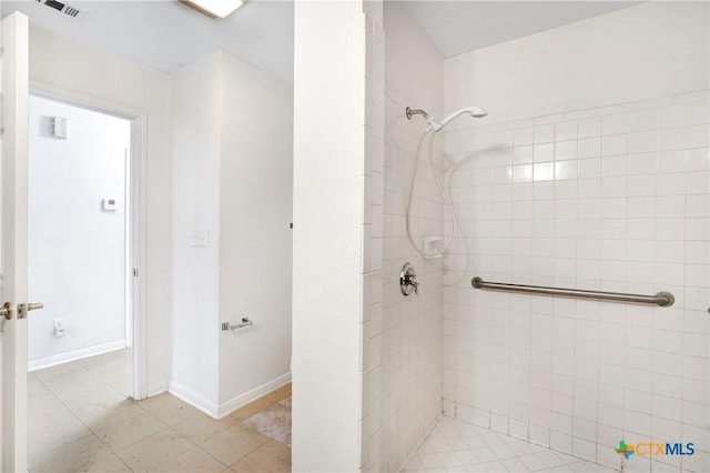 bathroom featuring a tile shower and tile patterned floors