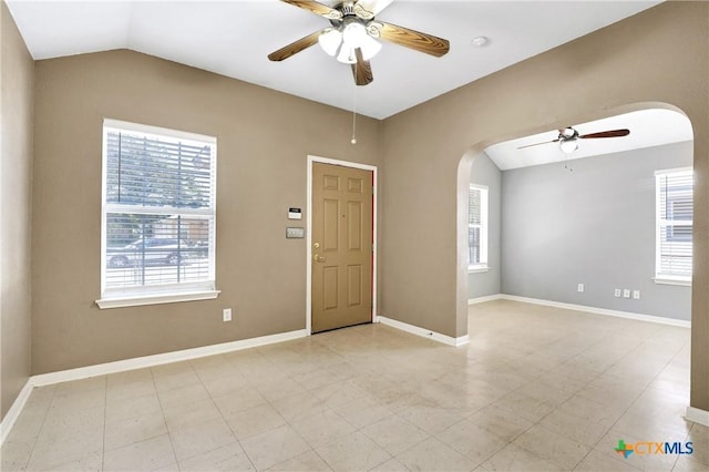 spare room featuring lofted ceiling and ceiling fan