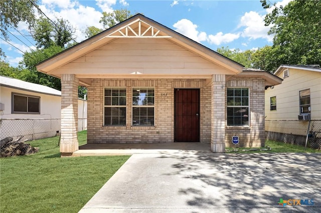 bungalow-style home with a front lawn