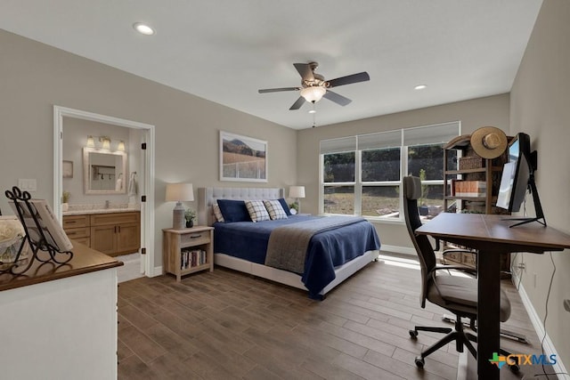 bedroom featuring ensuite bath, baseboards, dark wood-type flooring, and recessed lighting