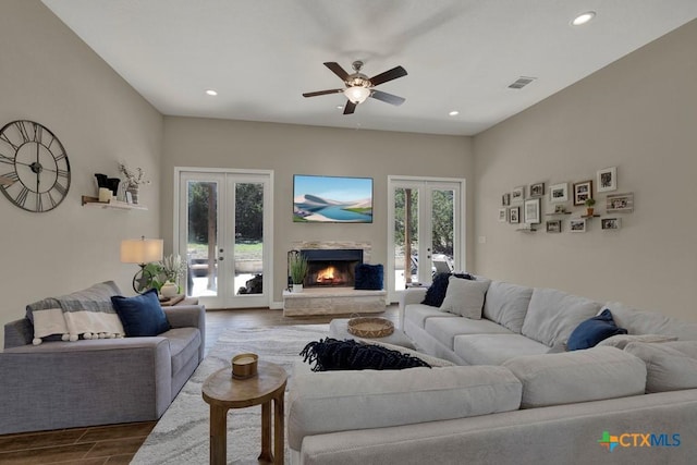 living area with recessed lighting, dark wood finished floors, visible vents, a ceiling fan, and french doors