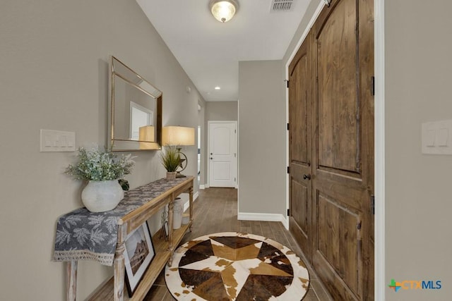 interior space featuring recessed lighting, wood finished floors, visible vents, and baseboards