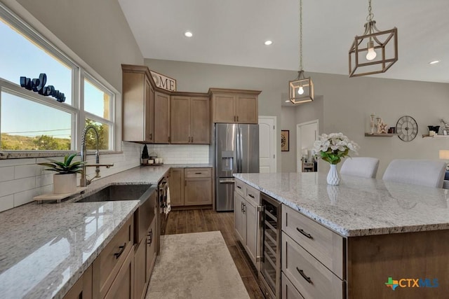 kitchen with a kitchen island, tasteful backsplash, wine cooler, and stainless steel fridge