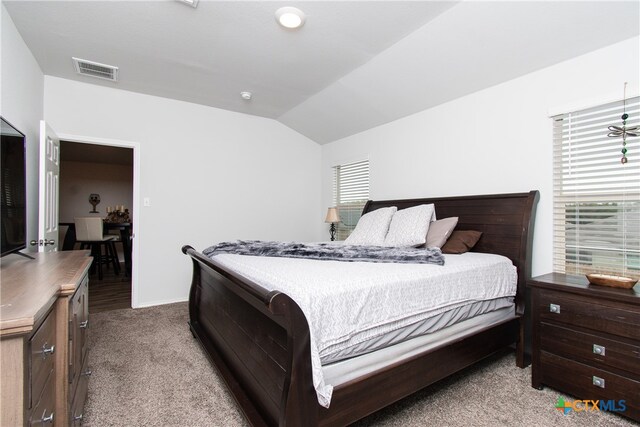 carpeted bedroom with vaulted ceiling