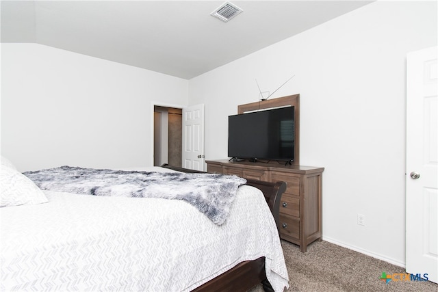 carpeted bedroom with lofted ceiling