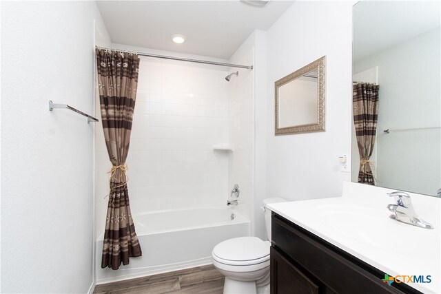 full bathroom featuring shower / bath combo, wood-type flooring, toilet, and vanity