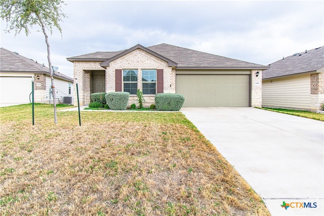 ranch-style home with a garage, central AC, and a front yard