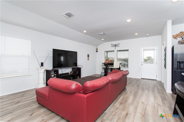 living room featuring light hardwood / wood-style floors and vaulted ceiling