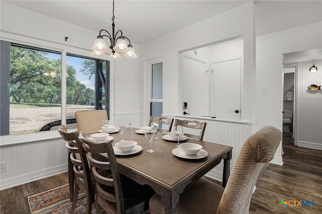 dining room featuring dark wood-type flooring and a chandelier