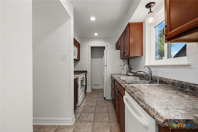 kitchen featuring light tile patterned flooring, sink, pendant lighting, white appliances, and backsplash