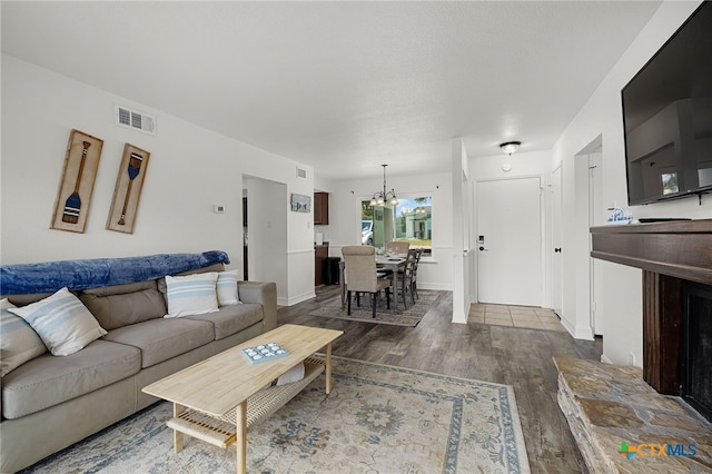 living room with an inviting chandelier and wood-type flooring