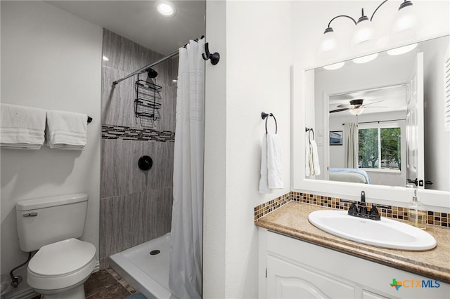 bathroom featuring vanity, decorative backsplash, curtained shower, and toilet