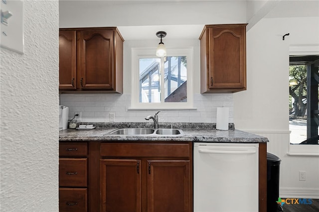 kitchen with a healthy amount of sunlight, sink, pendant lighting, and dishwasher