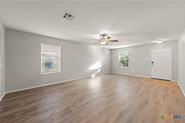 spare room with light hardwood / wood-style flooring and ceiling fan