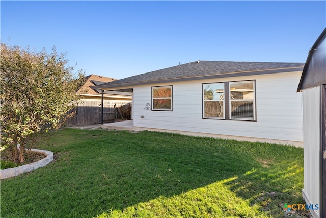 rear view of property with a patio area and a yard