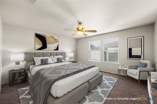 carpeted bedroom featuring a textured ceiling and ceiling fan