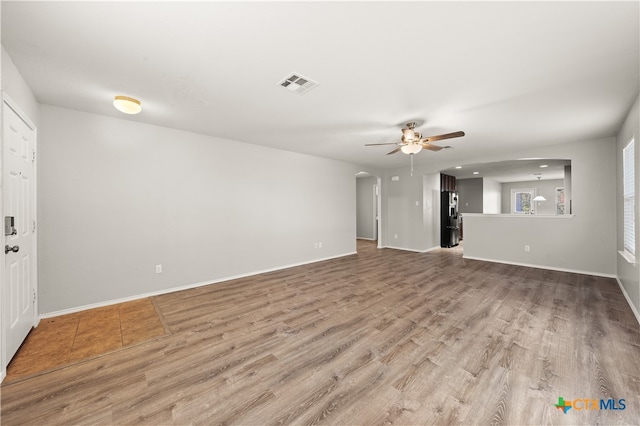 unfurnished living room featuring ceiling fan and wood-type flooring