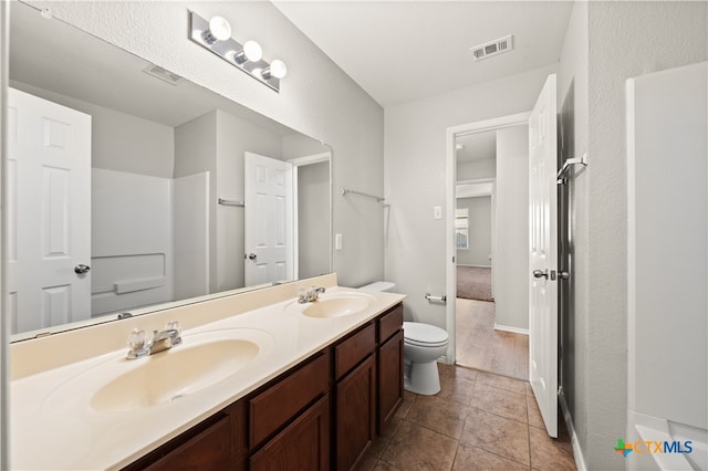 bathroom with tile patterned floors, vanity, and toilet