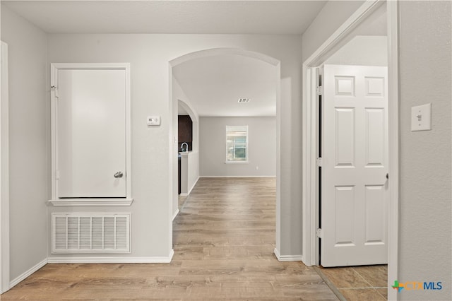 hallway with light hardwood / wood-style flooring