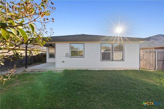 back of property featuring a yard and a patio