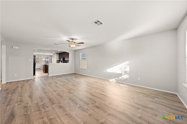 unfurnished living room with ceiling fan and light hardwood / wood-style floors