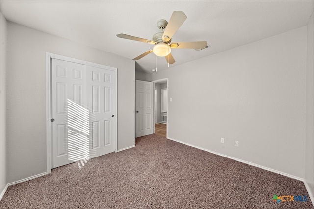 unfurnished bedroom featuring carpet, ceiling fan, and a closet