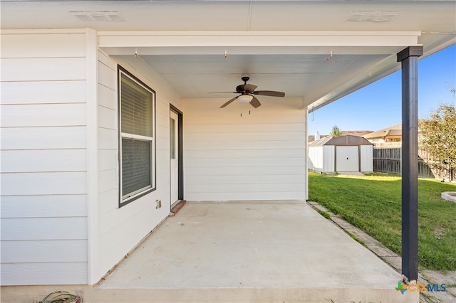 view of patio / terrace with ceiling fan and a shed