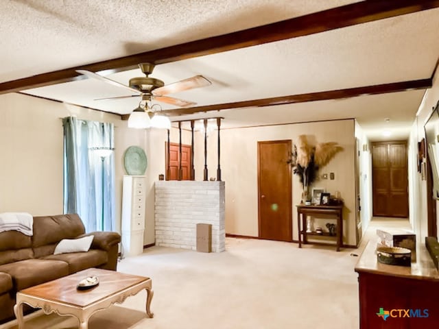 living room with ceiling fan, beamed ceiling, a textured ceiling, and light colored carpet