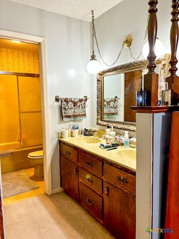 full bathroom with vanity, shower / tub combination, a textured ceiling, and toilet