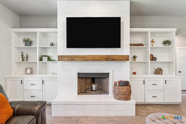100 Metheglin Dr, Temple, TX 76502 - living area featuring light wood-style floors, a brick fireplace, and built in shelves