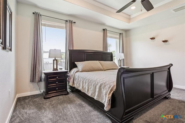 100 Metheglin Dr, Temple, TX 76502 - bedroom with dark colored carpet, ornamental molding, a ceiling fan, and a tray ceiling