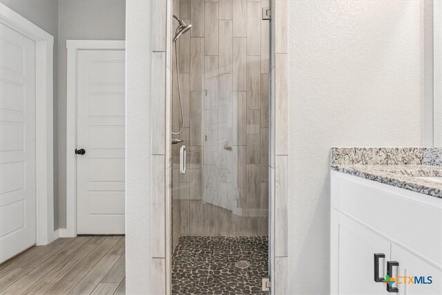 100 Metheglin Dr, Temple, TX 76502 - full bathroom with a stall shower, vanity, and wood finish floors