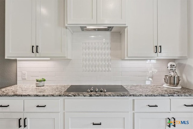 100 Metheglin Dr, Temple, TX 76502 - kitchen with white cabinets, decorative backsplash, and dark stone counters