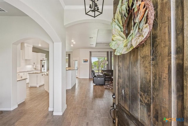 100 Metheglin Dr, Temple, TX 76502 - foyer entrance with wood finished floors, recessed lighting, crown molding, and arched walkways