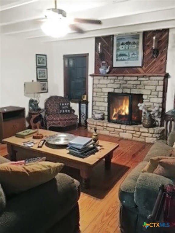 4630 Lantana Rd, Belton, TX 76513 - living room featuring wood finished floors, a stone fireplace, and a ceiling fan